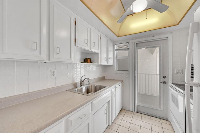 Your Kitchen Features lots of Cabinet Space, is Bright & Has A Door to Your Balcony! Being Sold Furnished, Turn-Key. Impact Windows & Doors also include Blinds and Retractable Screen Doors! | Image 5