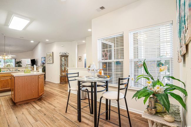 Dining room featuring light wood-type flooring, recessed lighting, and lofted ceiling | Image 7