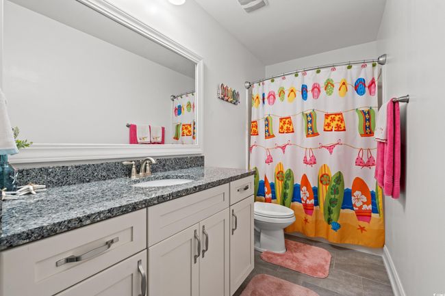 Full bath featuring vanity, tile patterned flooring, and curtained shower | Image 27
