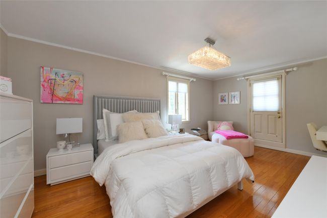 Bedroom featuring ornamental molding, multiple windows, and light wood-style floors | Image 14