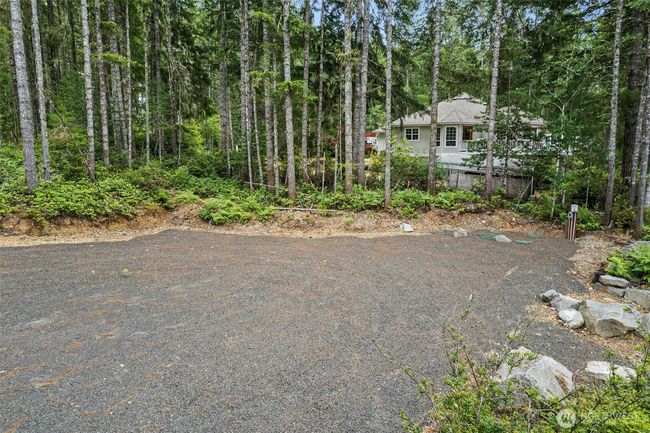 The future home site is perfect for your travel trailer also. There is RV hookup for sewer drainage right there!! This owner thought of everything, you will see that once you tour this property. | Image 15