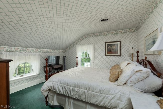 Bedroom with carpet floors and vaulted ceiling | Image 33