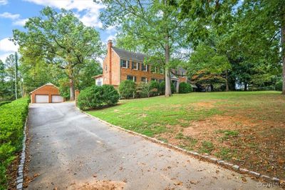 Paved front driveway with granite pavers as curbing. | Image 1