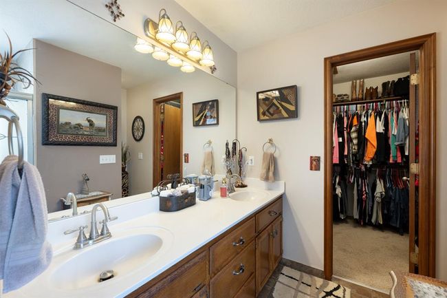 Bathroom featuring a spacious closet, double vanity, and a sink | Image 19