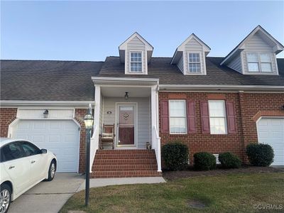 View of front of house featuring a front yard and a garage | Image 1