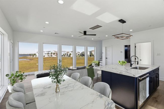 Look out over the bay while enjoying your meals in this stunning dining area offering picturesque views | Image 8