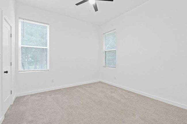 Empty room featuring baseboards, ceiling fan, and light colored carpet | Image 22