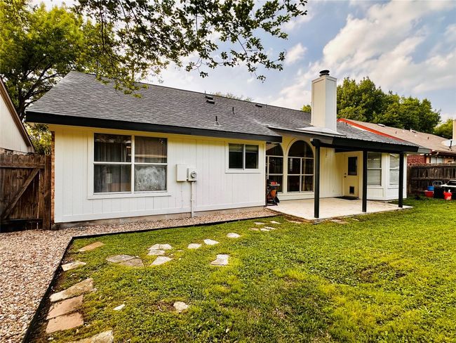 Rear view of property with a yard, a patio, roof with shingles, fence, and a chimney | Image 24