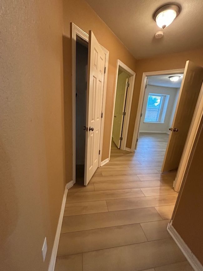 Corridor featuring light wood finished floors and arched walkways | Image 21