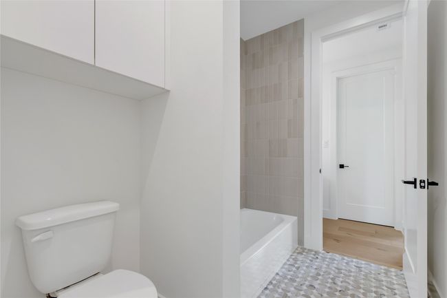 Full bath with toilet and wood finished floors | Image 30