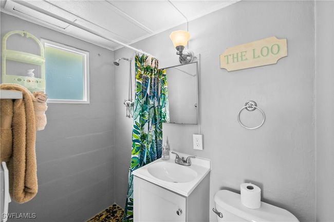 Bathroom with toilet, vanity, and walk in shower | Image 40