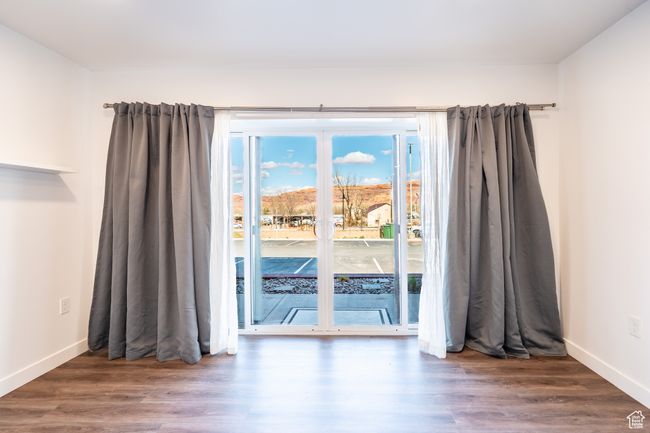 Empty room featuring baseboards and wood finished floors | Image 8