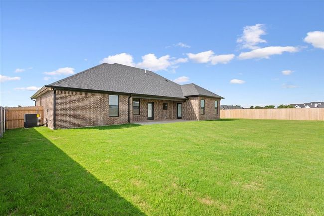 Back of house with a shingled roof, brick siding, and a patio area | Image 39