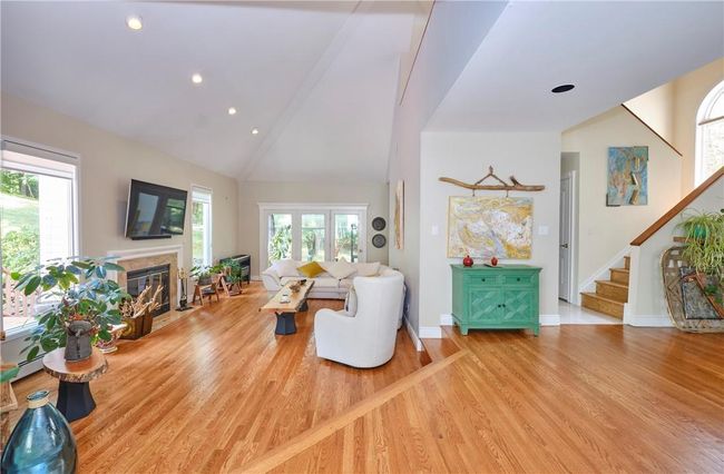 Living room featuring high vaulted ceiling and wood-type flooring | Image 16