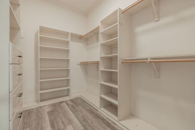 Spacious closets featuring built-ins and wood flooring | Image 26