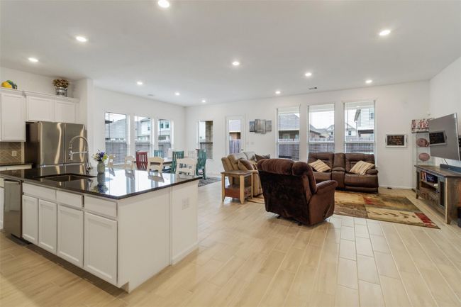 The windows are plentiful in this living/dining room space. | Image 14