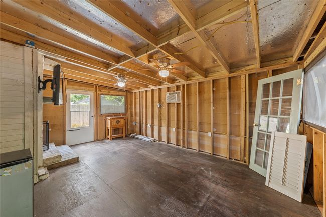 Miscellaneous room with a wall mounted AC, a wood stove, and a ceiling fan | Image 23
