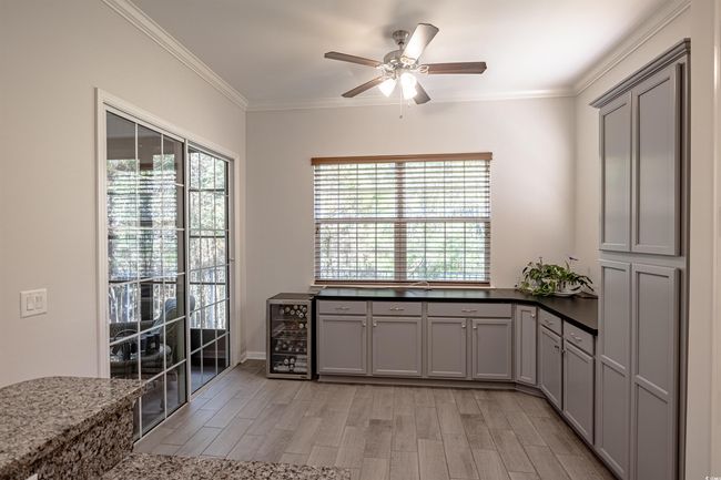 Kitchen with gray cabinets, light hardwood / wood-style flooring, and wine cooler | Image 24