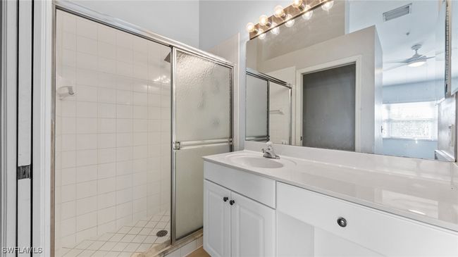 Full bath featuring a shower stall, vanity, and visible vents | Image 14