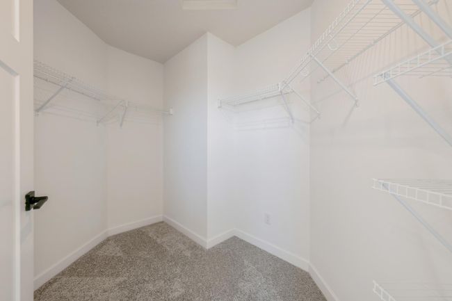 (*Photo of actual home) The primary bedroom walk-in closet | Image 12