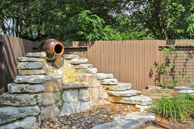 Unwind to the calming sounds of the custom waterfall feature. | Image 31