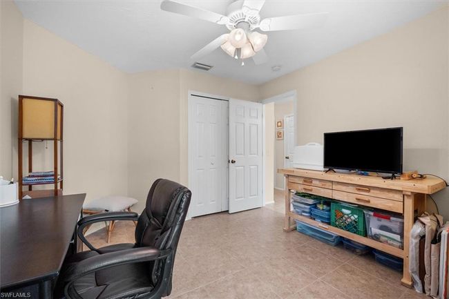 Office space featuring light tile patterned flooring, visible vents, and ceiling fan | Image 12