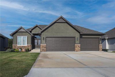 View of front of home featuring a garage and a front lawn | Image 1