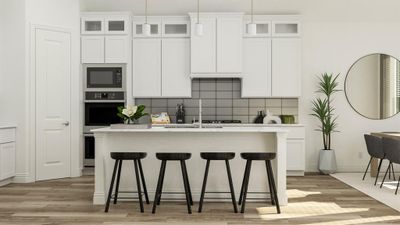 Kitchen with an island with sink, light hardwood / wood-style floors, black microwave, oven, and decorative backsplash | Image 2