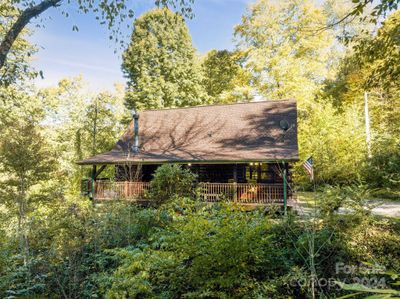 Side covered deck with view to left and drive to right | Image 2