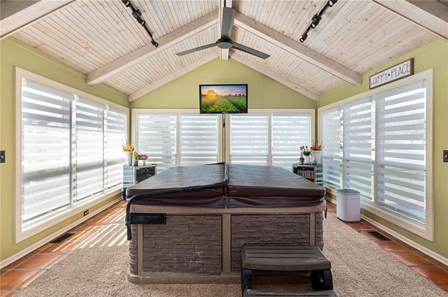 Sunroom / solarium featuring rail lighting, a wealth of natural light, and wooden ceiling | Image 18
