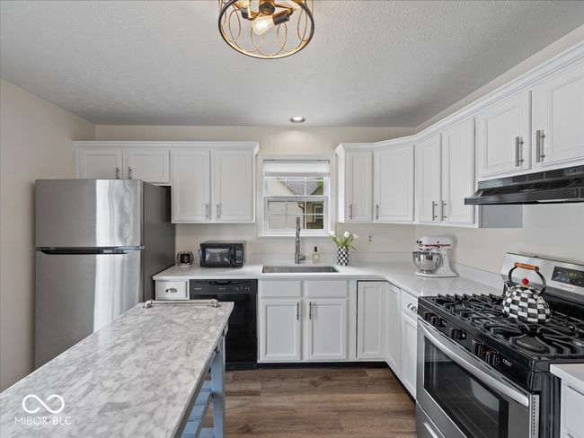 kitchen has lots of room - either leave open or add a cafe table. | Image 10