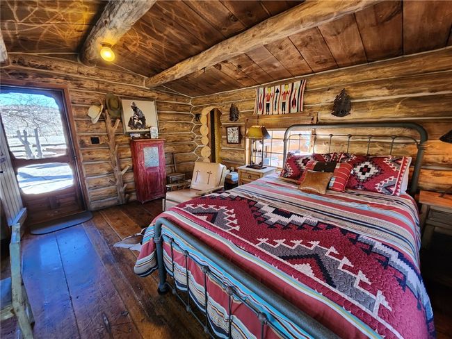 Bedroom with wood ceiling, lofted ceiling with beams, and hardwood / wood-style flooring | Image 15