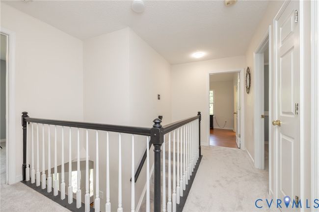 Hallway featuring an upstairs landing, carpet flooring, and a textured ceiling | Image 18