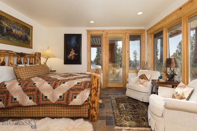 Entry level Bedroom 2 with sun room seating area and access to exterior patio seating. | Image 54