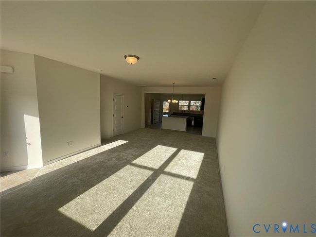 Unfurnished room with a chandelier and carpet flooring | Image 4