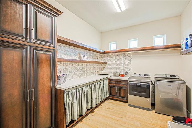 Extra-large laundry room, mop sink, broom closet, kennel area for dogs | Image 22