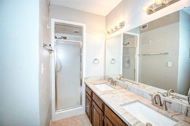 Bathroom featuring tile patterned floors, vanity, and an enclosed shower | Image 22