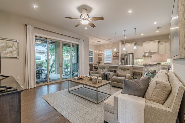Living room with a ceiling fan, dark wood-type flooring, recessed lighting, and baseboards | Image 7