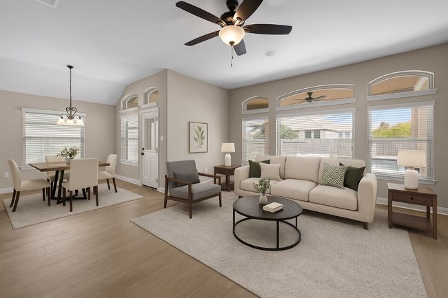 Living area with a ceiling fan, wood finished floors, a chandelier, and lofted ceiling | Image 6