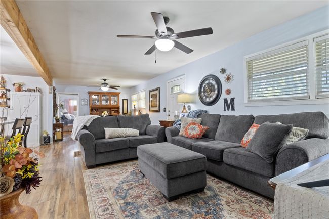 Living area with a ceiling fan and hardwood / wood-style flooring | Image 6