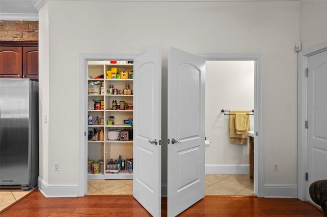 Walk in pantry with shelving and separate storage under the stairs | Image 12
