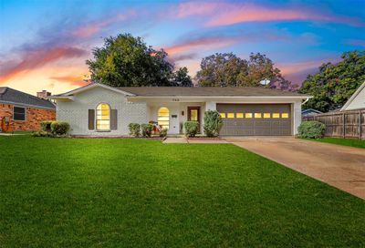 View of front facade featuring a yard and a garage | Image 1