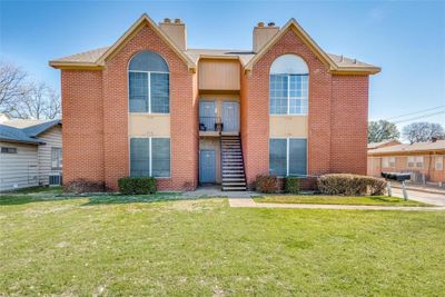 View of front of home with central air condition unit and a front lawn | Image 1