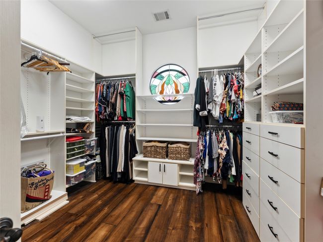 Walk in closet featuring dark wood finished floors | Image 23