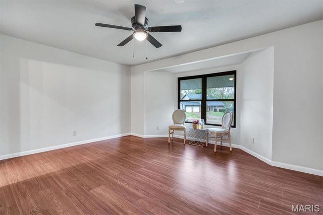 Unfurnished bedroom featuring wood finished floors, a ceiling fan, and a closet | Image 21