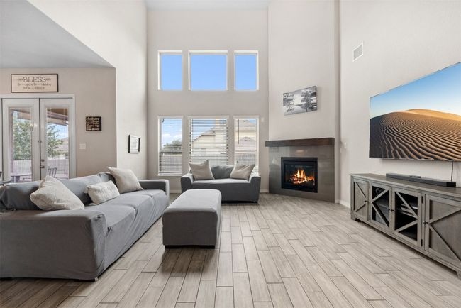 The corner fireplace adds both warmth and character to the room, creating a cozy focal point | Image 8