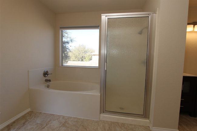 Bathroom featuring a garden tub and a shower stall | Image 14