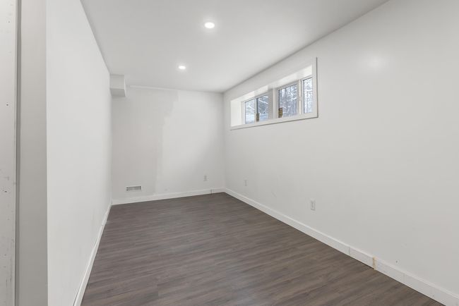 Below grade area with visible vents, recessed lighting, dark wood-style flooring, and baseboards | Image 24