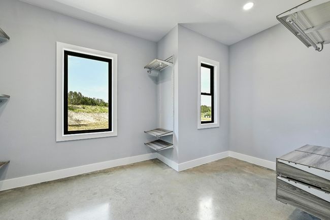 The oversized primary walk-in closet comes with a high-end organizational system. | Image 23