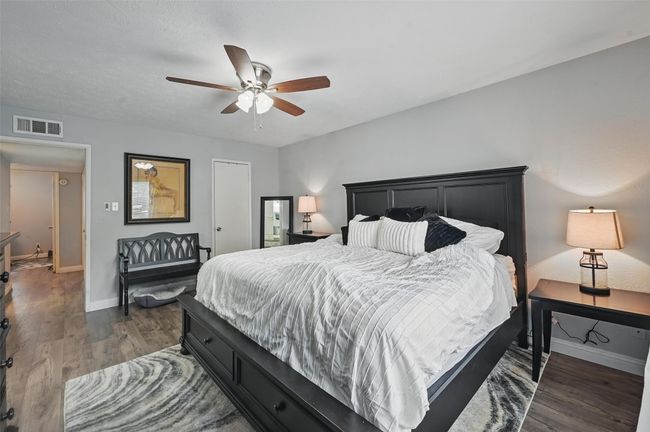 Bedroom featuring dark wood-type flooring and a ceiling fan | Image 25